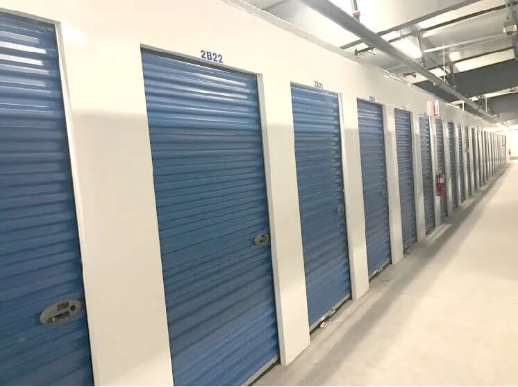 Row of numbered climate controlled storage units with blue roll-up doors